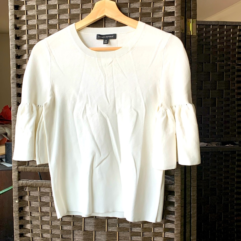 Beautiful simple cream sweater top with adorable sleeves.